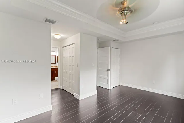 a bathroom with a granite countertop toilet sink and mirror