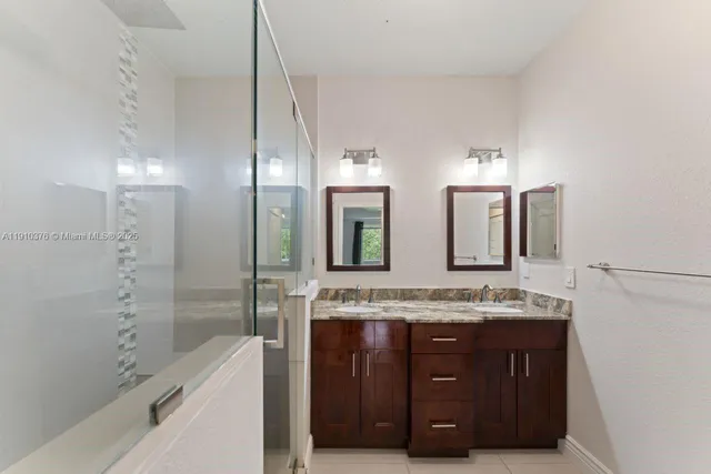 an empty room with wooden floor chandelier fan and windows