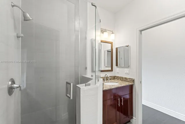 an empty room with a window and a ceiling fan