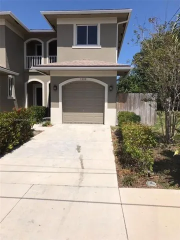 a large kitchen with a stove a sink and a refrigerator