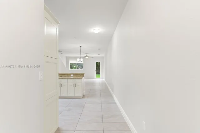 a bathroom with a granite countertop toilet sink mirror and vanity