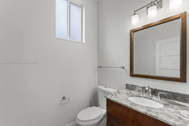 a view of a kitchen with furniture and a ceiling fan