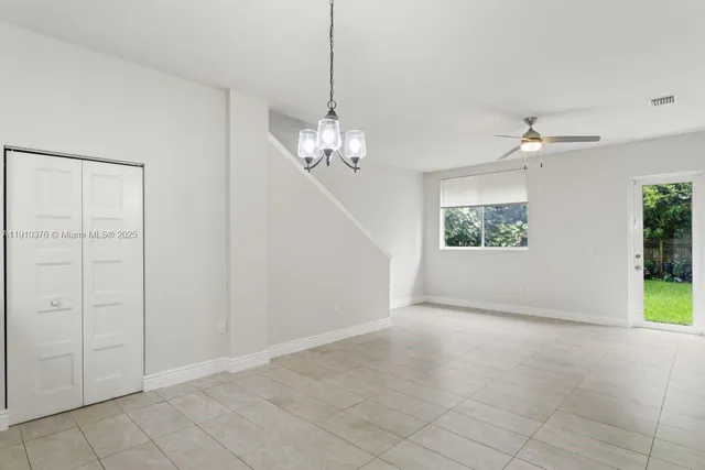 a view of a hallway with wooden floor and windows