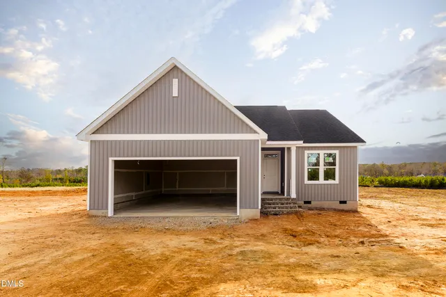 a view of house with backyard and ocean view