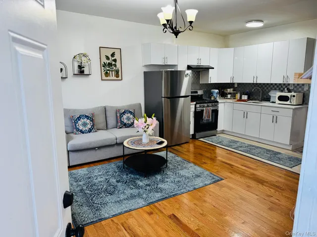 a kitchen with a refrigerator a stove a microwave and cabinets