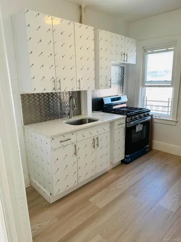 a kitchen with a stove a sink and a refrigerator