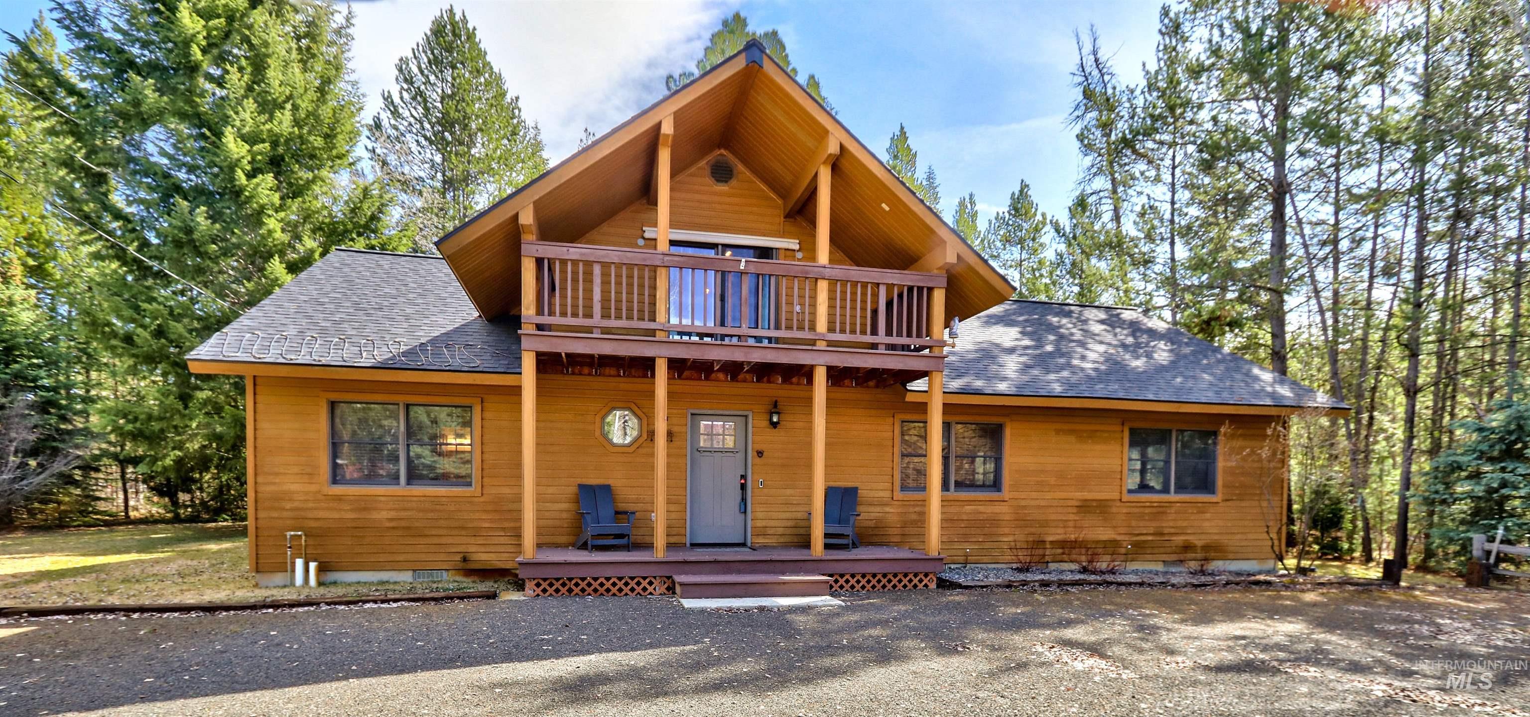 View of front facade featuring a shingled roof and covered porch