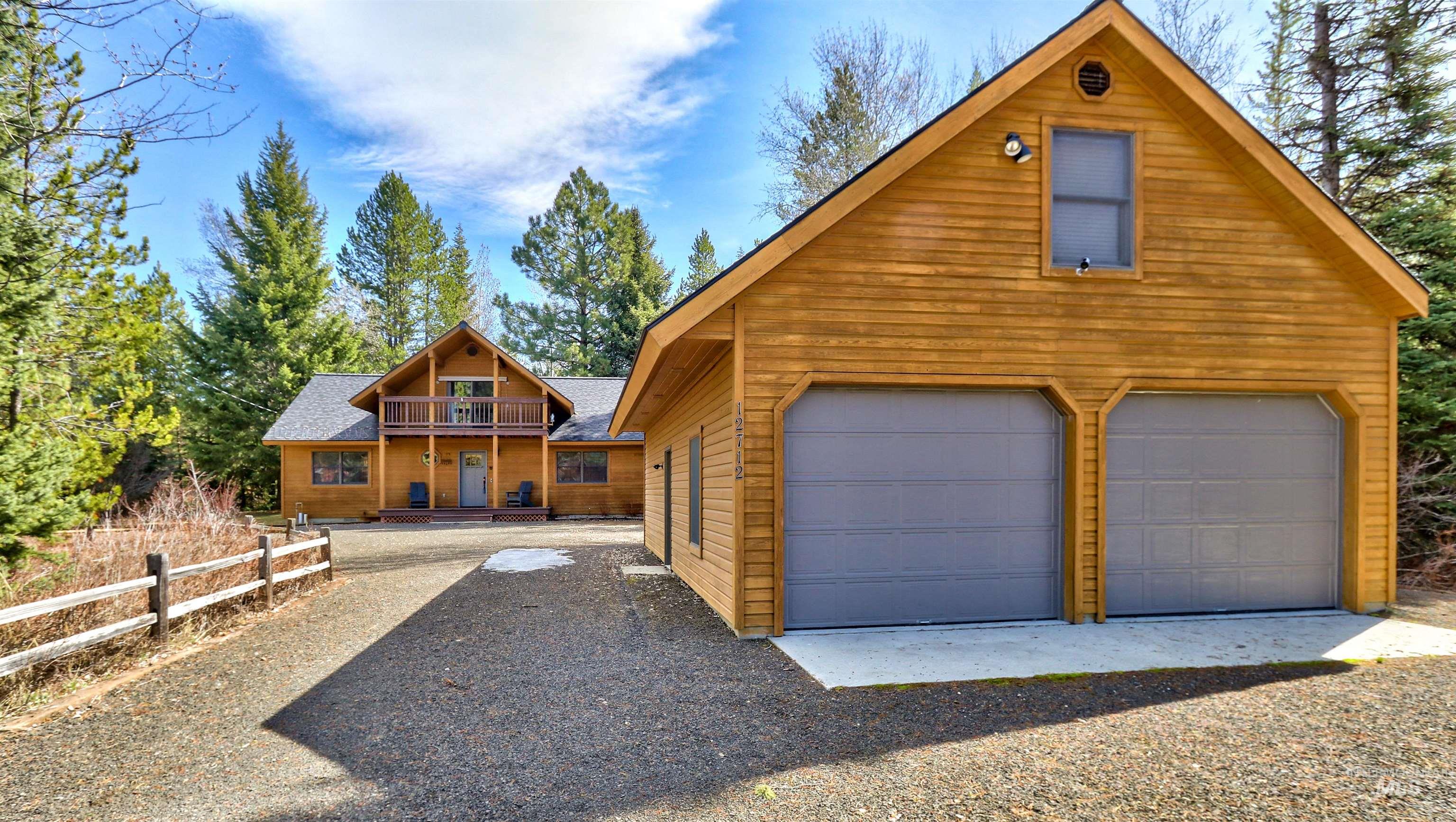 12712 Hereford Road Donnelly, ID 83615 - Photo 2 of 50 Rustic home featuring an outbuilding, a garage, and a shingled roof