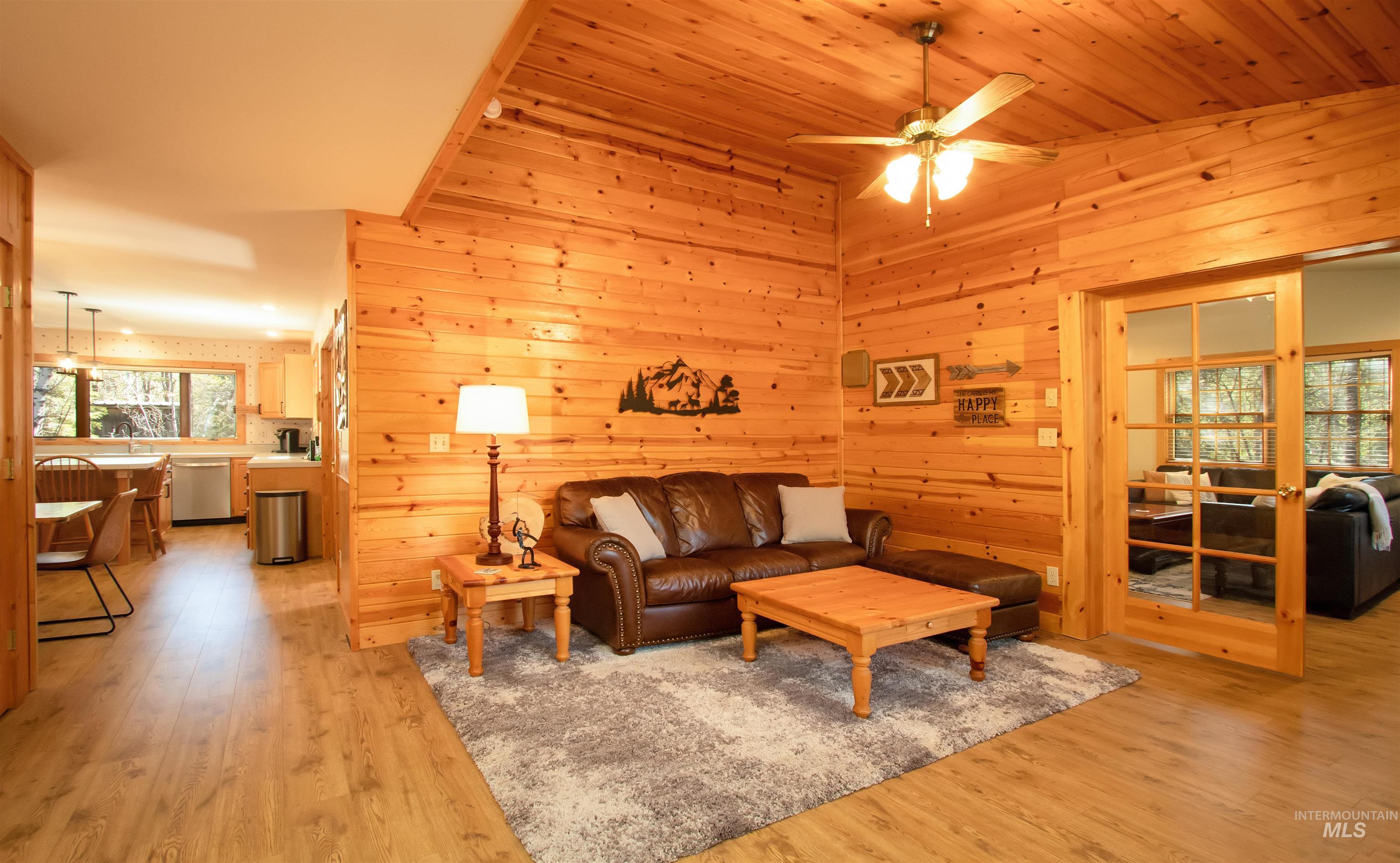 12712 Hereford Road Donnelly, ID 83615 - Photo 21 of 50 Living room featuring light wood-style flooring, wooden walls, and ceiling fan