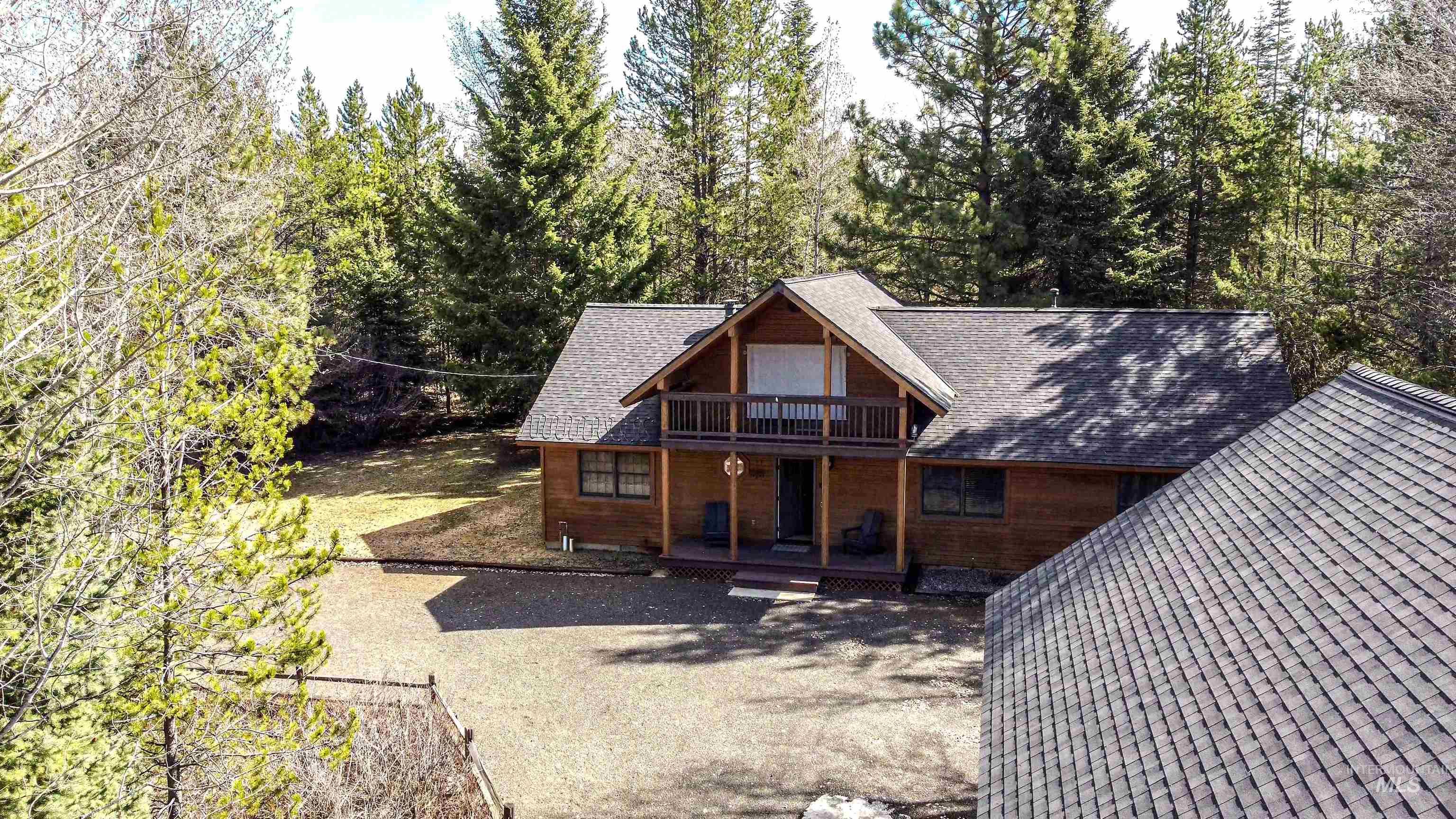12712 Hereford Road Donnelly, ID 83615 - Photo 28 of 50 View of front facade featuring a shingled roof, covered porch, and a balcony