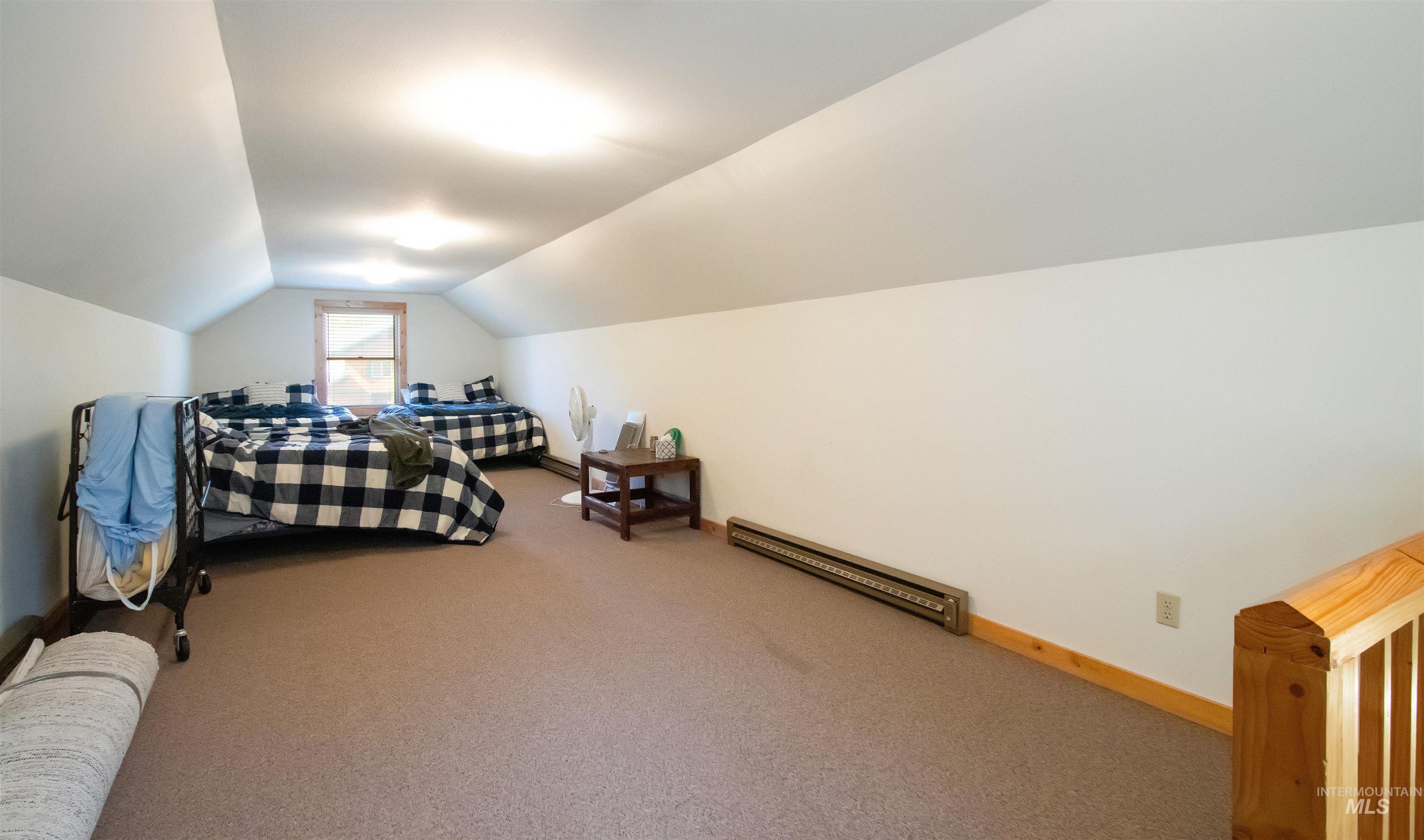 12712 Hereford Road Donnelly, ID 83615 - Photo 32 of 50 Carpeted bedroom with baseboards and a baseboard heating unit