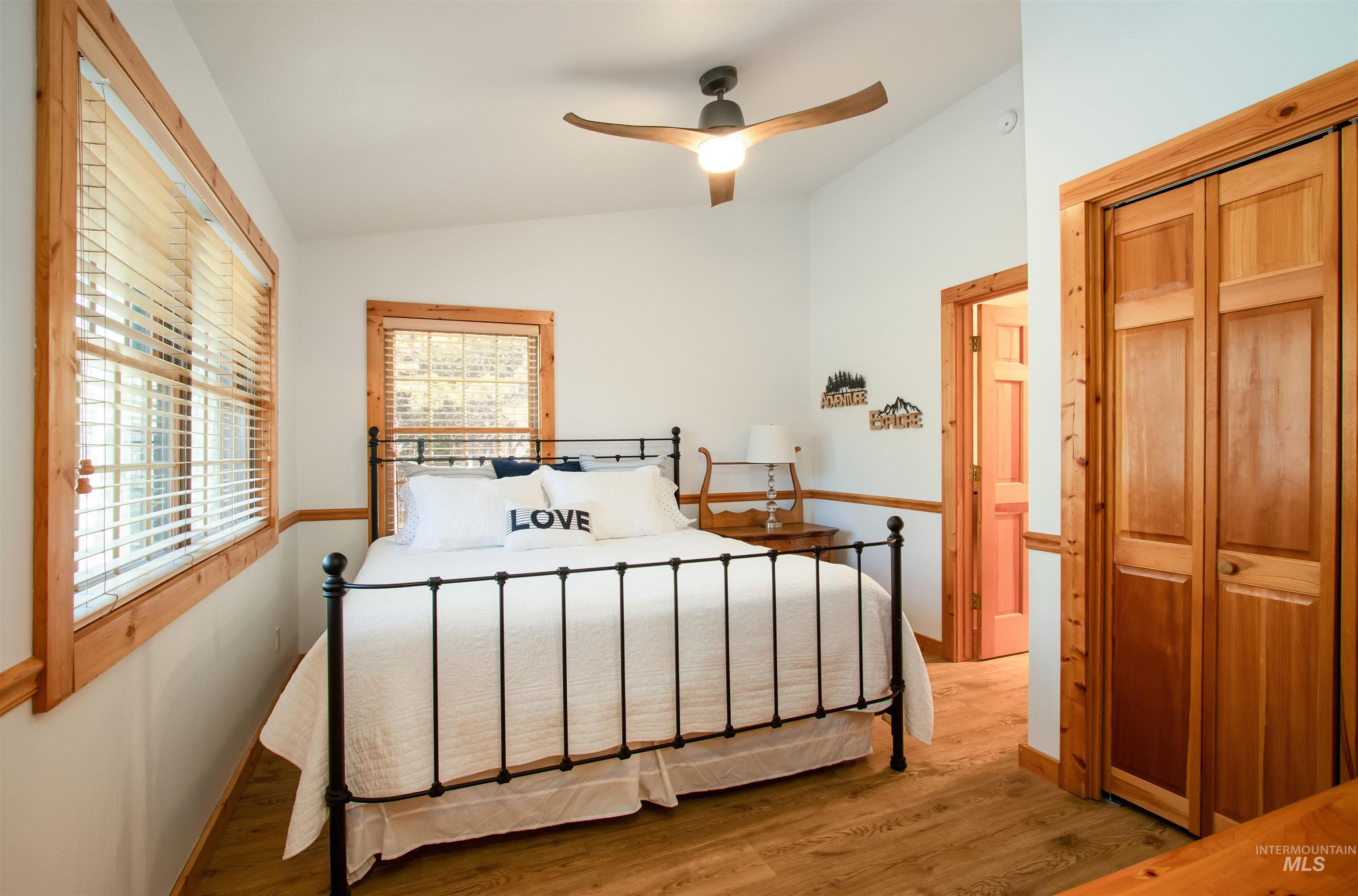 12712 Hereford Road Donnelly, ID 83615 - Photo 33 of 50 Bedroom featuring wood finished floors, lofted ceiling, ceiling fan, and a closet