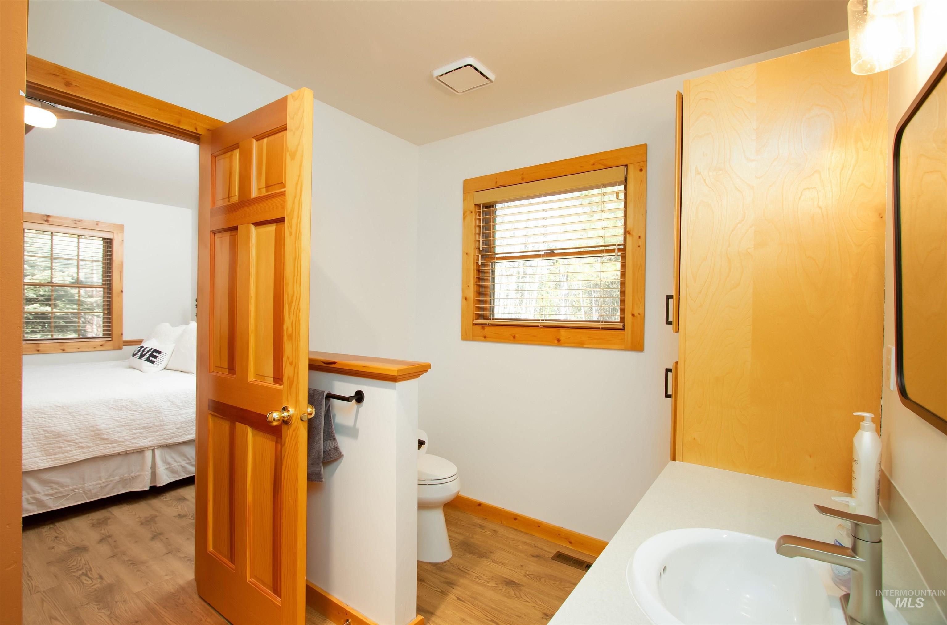 12712 Hereford Road Donnelly, ID 83615 - Photo 35 of 50 Bathroom featuring vanity, light wood-type flooring, and ensuite bathroom