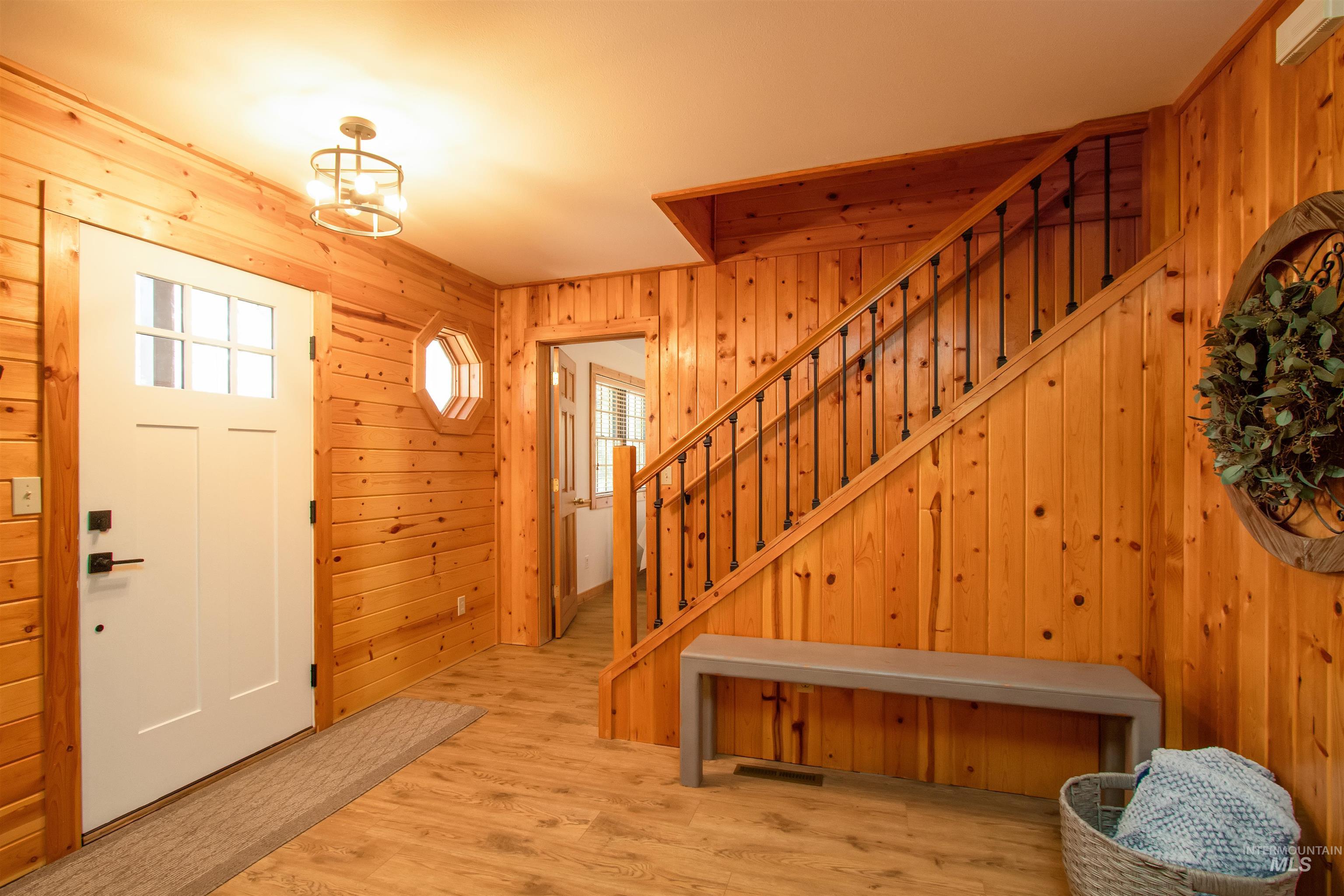 12712 Hereford Road Donnelly, ID 83615 - Photo 37 of 50 Foyer entrance with light wood-type flooring and wooden walls
