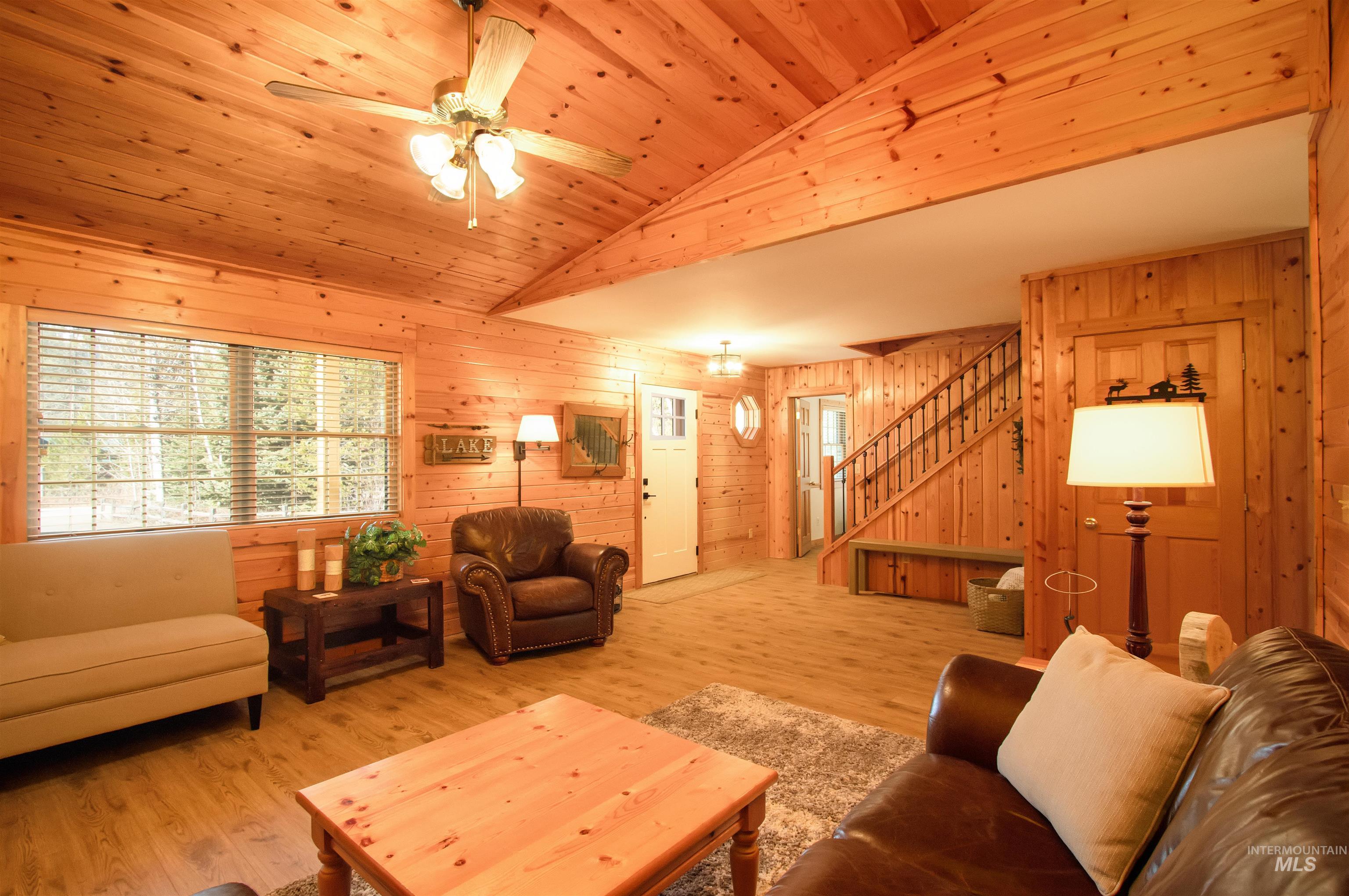 12712 Hereford Road Donnelly, ID 83615 - Photo 38 of 50 Living area featuring wood walls, a ceiling fan, wood finished floors, and a vaulted wood ceiling