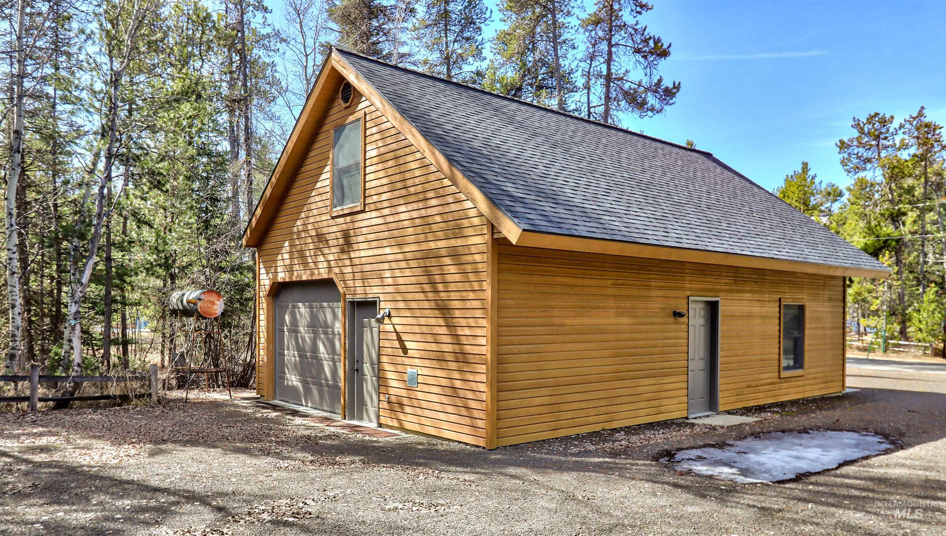 12712 Hereford Road Donnelly, ID 83615 - Photo 4 of 50 View of home's exterior featuring roof with shingles and a detached garage