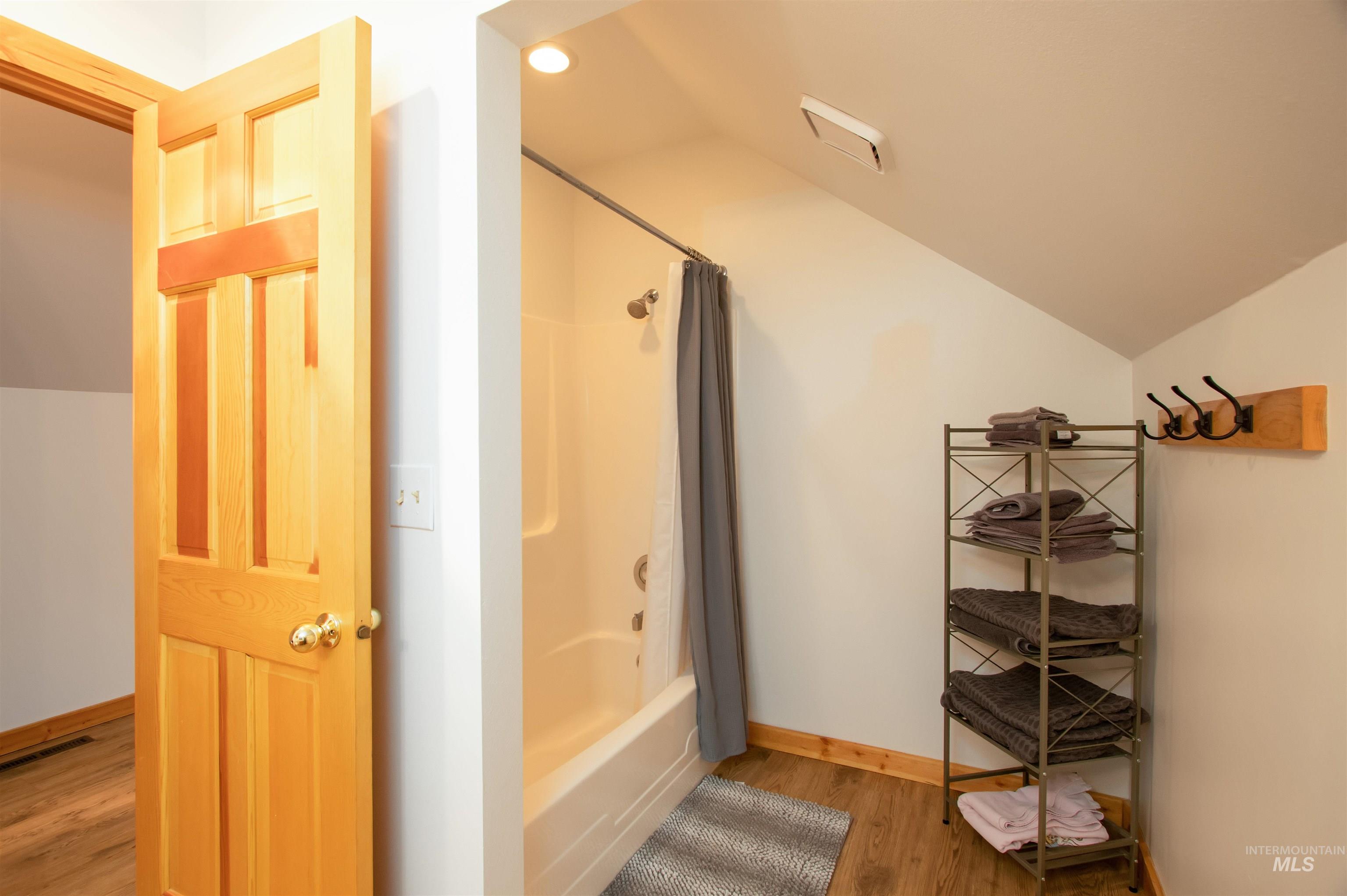 12712 Hereford Road Donnelly, ID 83615 - Photo 43 of 50 Full bath with lofted ceiling, light wood-type flooring, and shower / bath combo