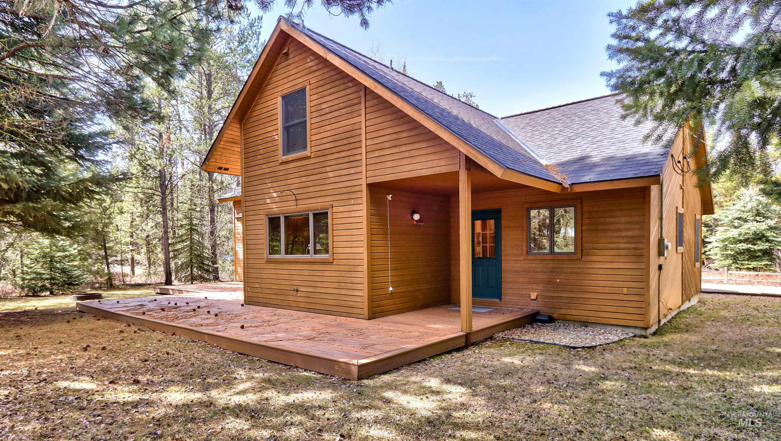 12712 Hereford Road Donnelly, ID 83615 - Photo 49 of 50 Back of house with a shingled roof and a deck