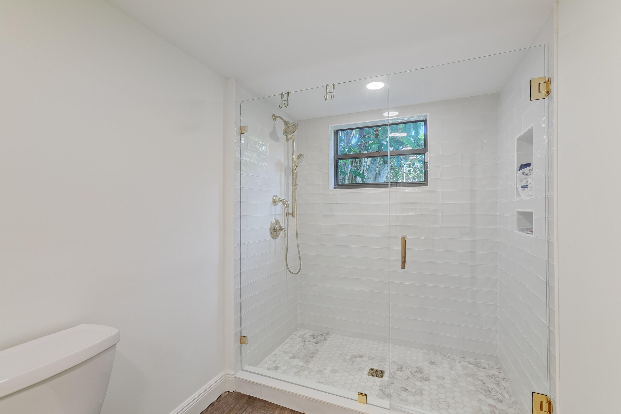 16622 Traders Crossing North, Unit 102 Jupiter, FL 33477 - Photo 13 of 19 a bathroom with a shower and toilet