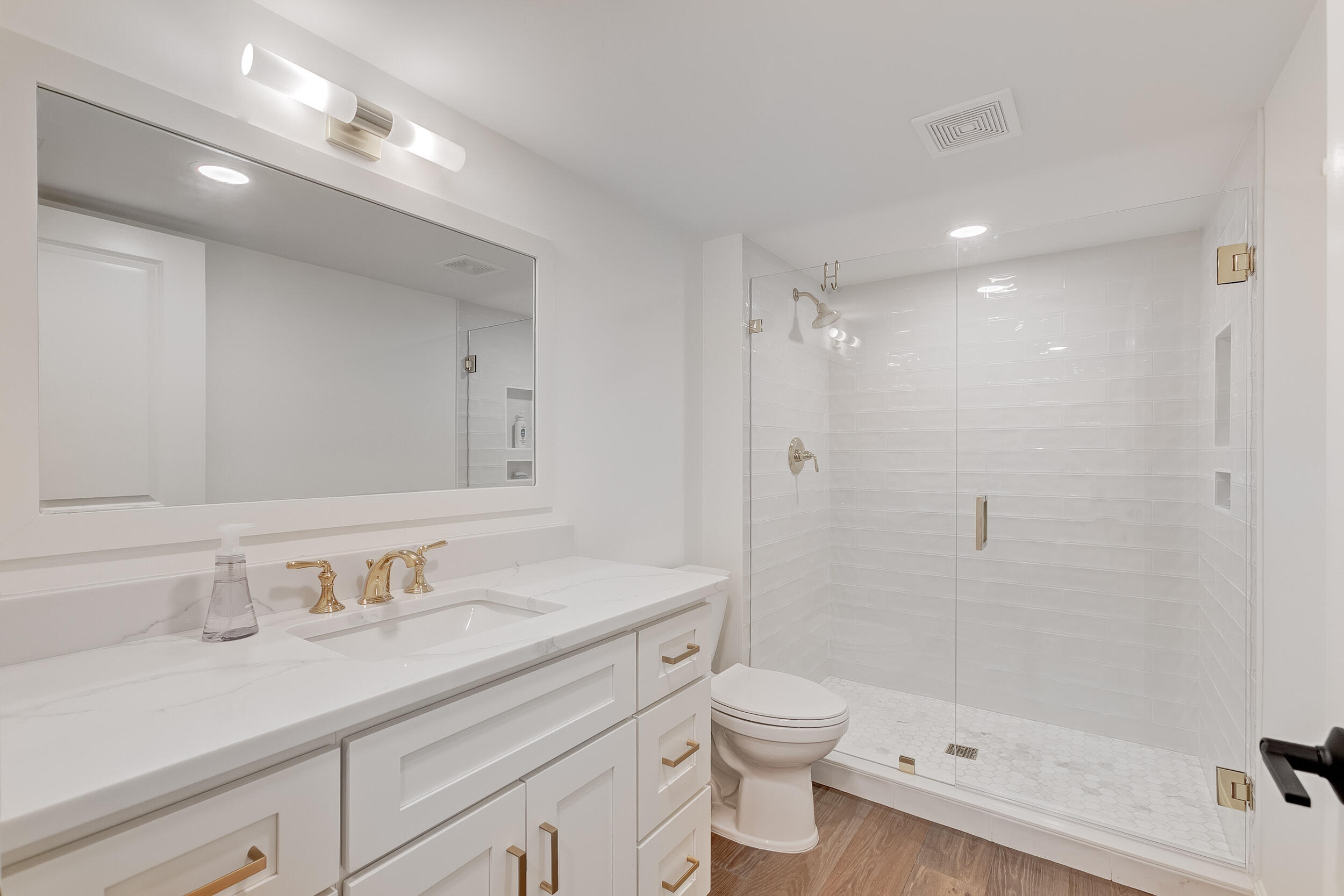 16622 Traders Crossing North, Unit 102 Jupiter, FL 33477 - Photo 16 of 19 a bathroom with a sink a toilet and shower