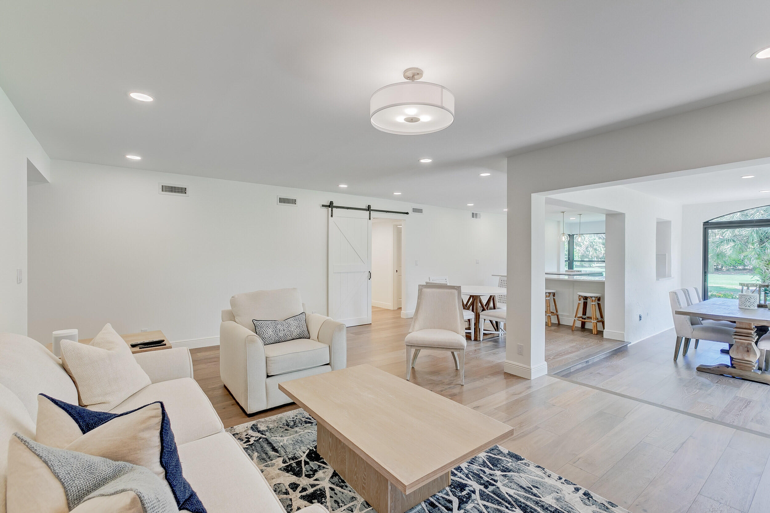 16622 Traders Crossing North, Unit 102 Jupiter, FL 33477 - Photo 4 of 19 a living room with furniture and wooden floor