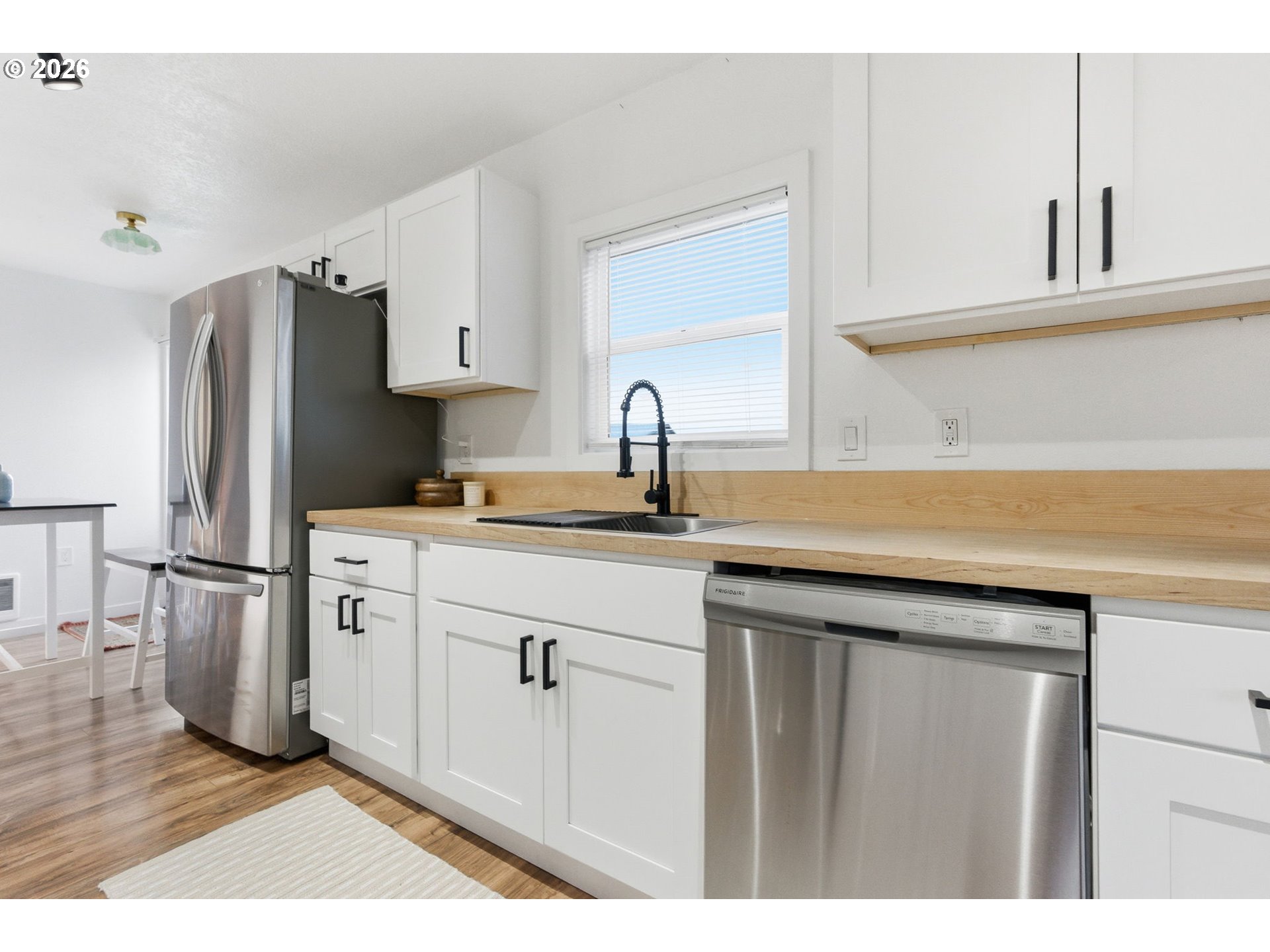16484 Front Avenue Oregon City, OR 97045 - Photo 11 of 34 a kitchen with appliances cabinets a sink and a counter top space