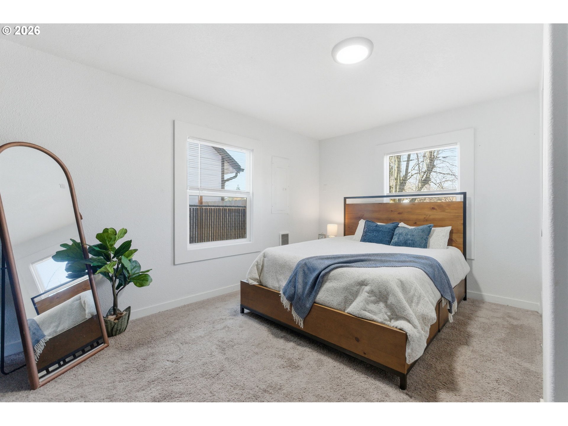 16484 Front Avenue Oregon City, OR 97045 - Photo 13 of 34 a bedroom with bed and a potted plant