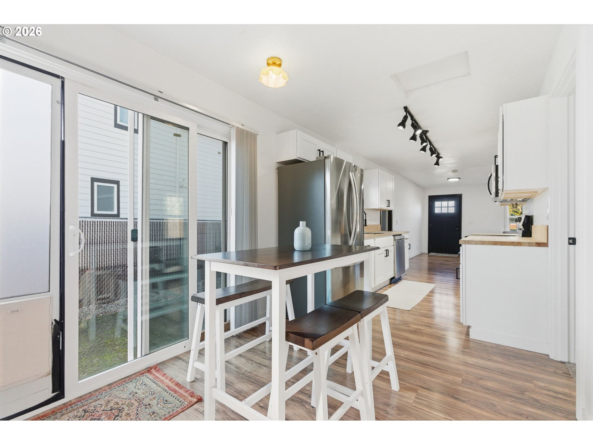 16484 Front Avenue Oregon City, OR 97045 - Photo 22 of 34 a view of a hallway with wooden floor windows and a living room