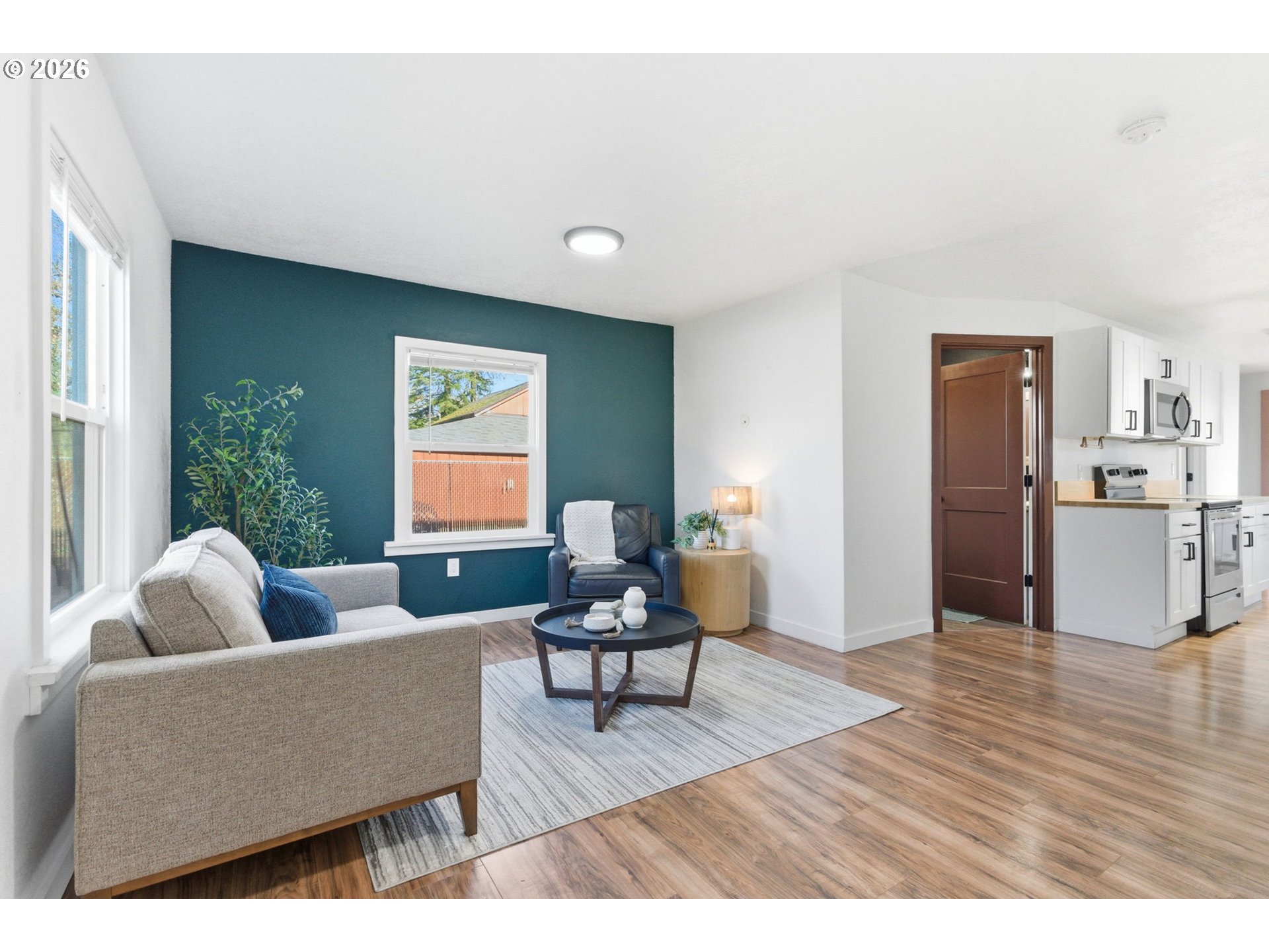 16484 Front Avenue Oregon City, OR 97045 - Photo 4 of 34 a living room with furniture and a dining table with wooden floor