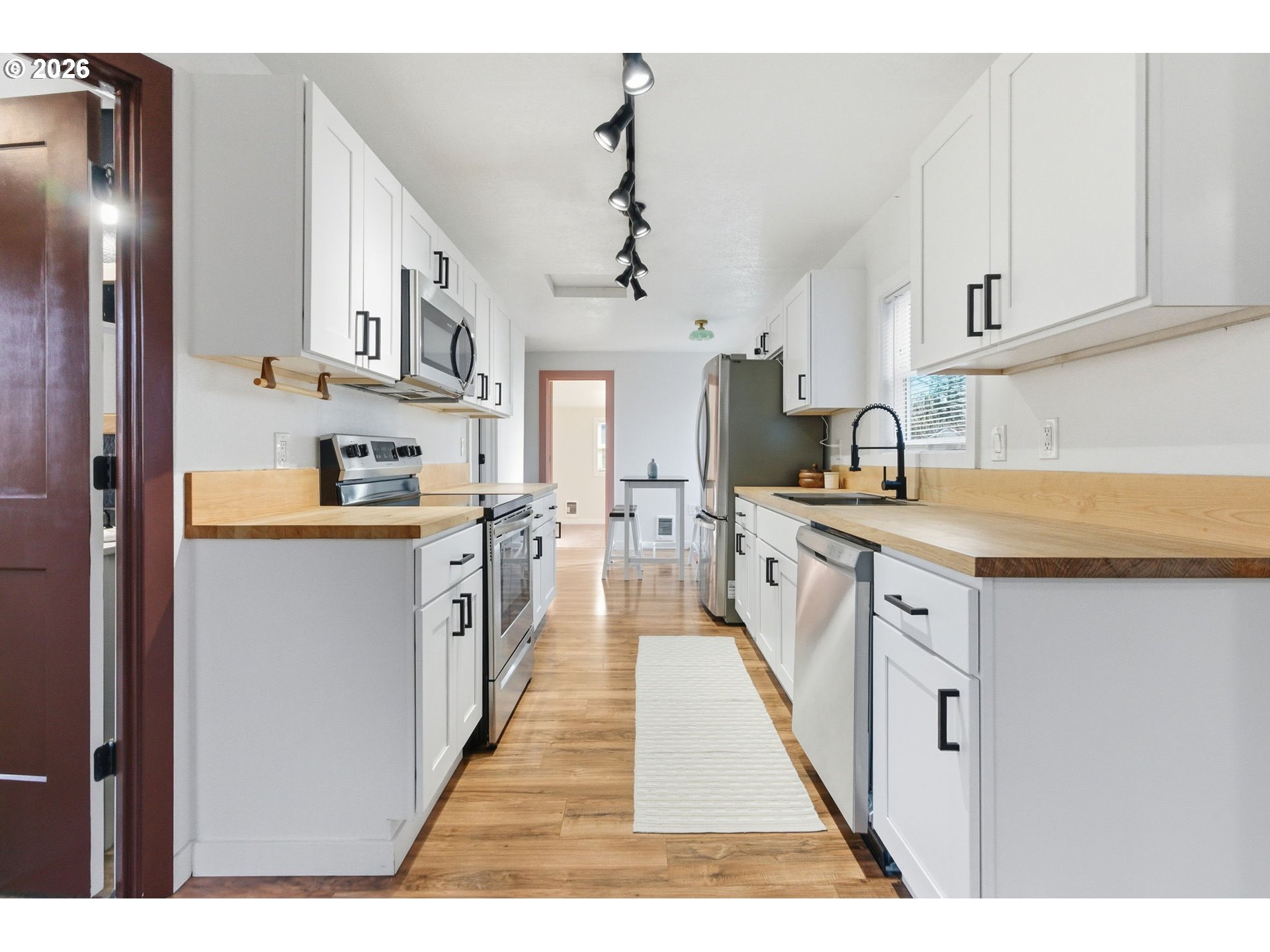 16484 Front Avenue Oregon City, OR 97045 - Photo 7 of 34 a kitchen with stainless steel appliances granite countertop a sink and cabinets