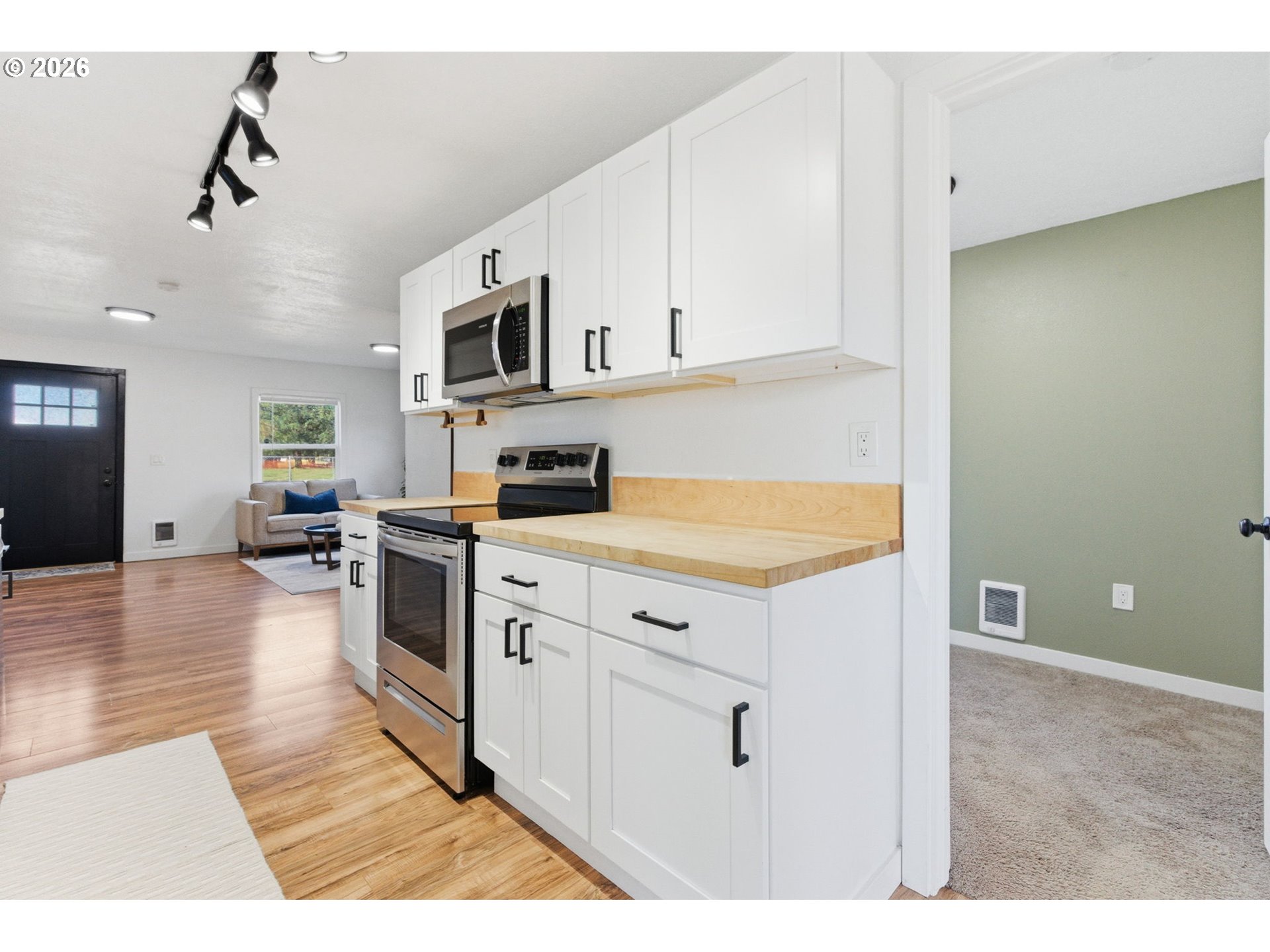 16484 Front Avenue Oregon City, OR 97045 - Photo 10 of 34 a kitchen with stainless steel appliances granite countertop a stove a sink and a refrigerator