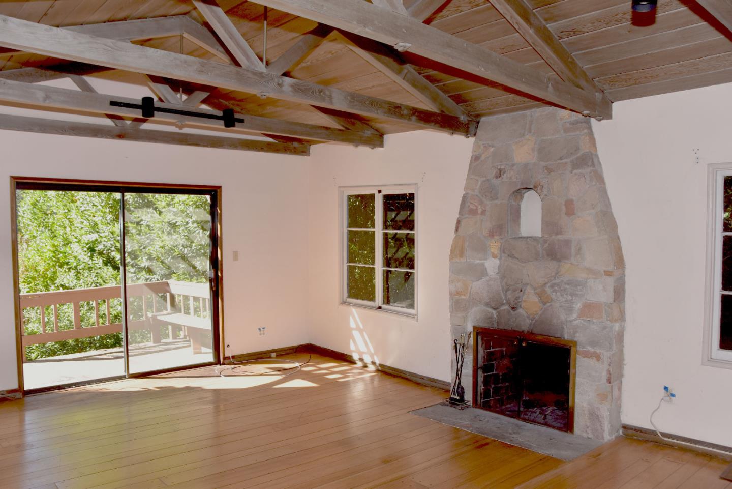 66 Poppy Lane Berkeley, CA 94708 - Photo 6 of 38 a view of empty room with wooden floor and fireplace