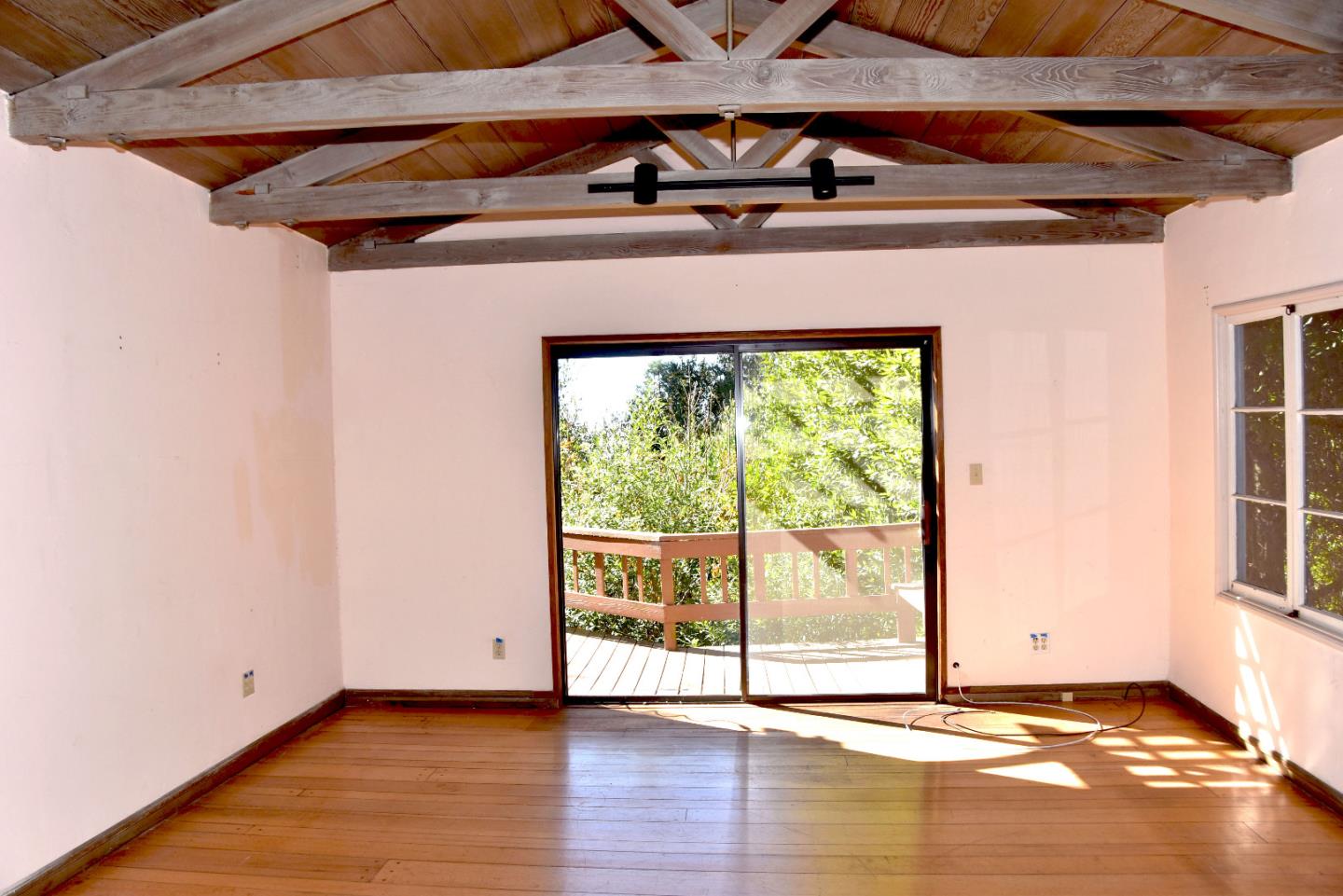 66 Poppy Lane Berkeley, CA 94708 - Photo 7 of 38 a view of an empty room with wooden floor and a window