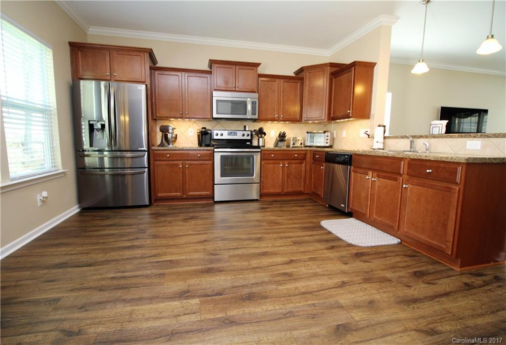 240 Mott Road Mooresville, NC 28115 - Photo 3 of 14 a kitchen with stainless steel appliances granite countertop a refrigerator sink and stove