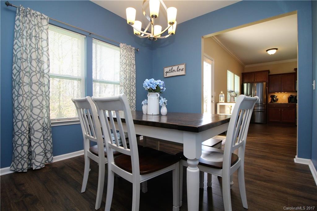 240 Mott Road Mooresville, NC 28115 - Photo 4 of 14 a view of a dining room with furniture a chandelier and wooden floor