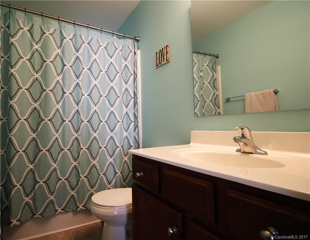 240 Mott Road Mooresville, NC 28115 - Photo 9 of 14 a bathroom with a sink a toilet and a mirror