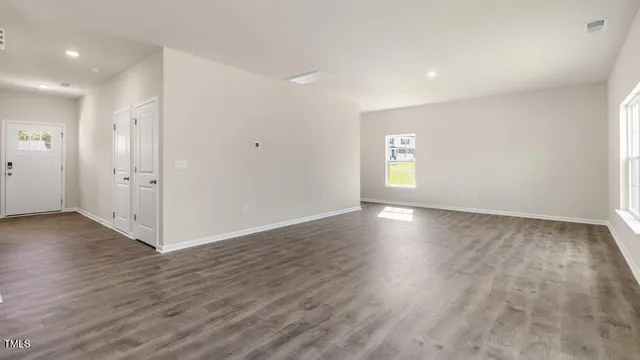 a view of wooden floor and windows in an empty room