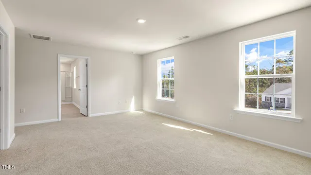 an empty room with windows and closet