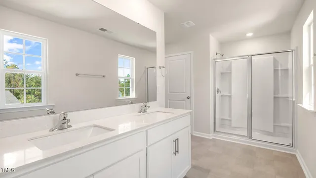 a bathroom with double sink and a mirror