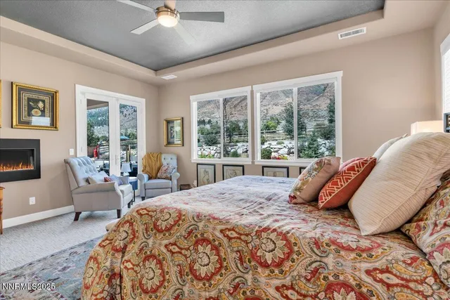 a bedroom with a bed and a large window