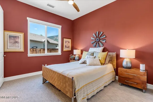 a bedroom with a bed and a potted plant