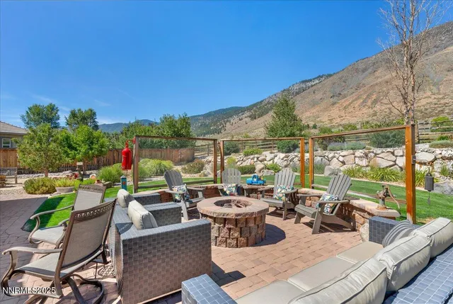 a view of a patio with couches potted plants and a table and chairs
