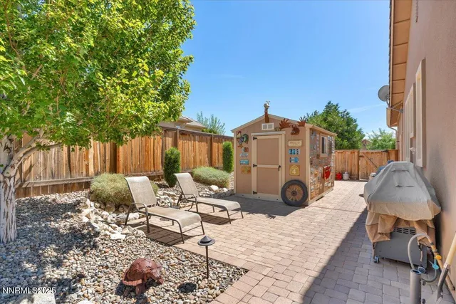 a view of a patio with table and chairs potted plants and a palm tree