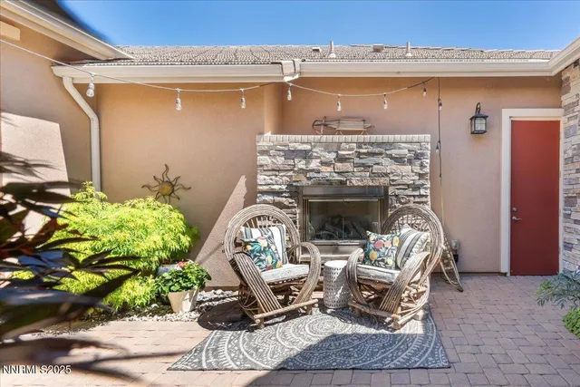 a front view of a house with outdoor seating