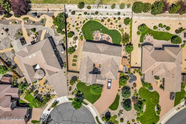 an aerial view of a house with a yard and a garden