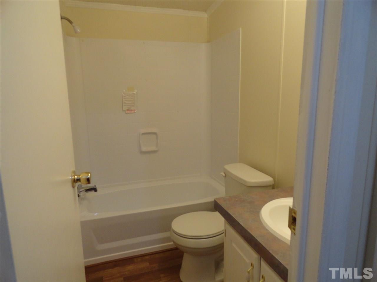 3388 Dirgie Mine Road Roxboro, NC 27574 - Photo 11 of 12 a bathroom with a toilet and a bathtub