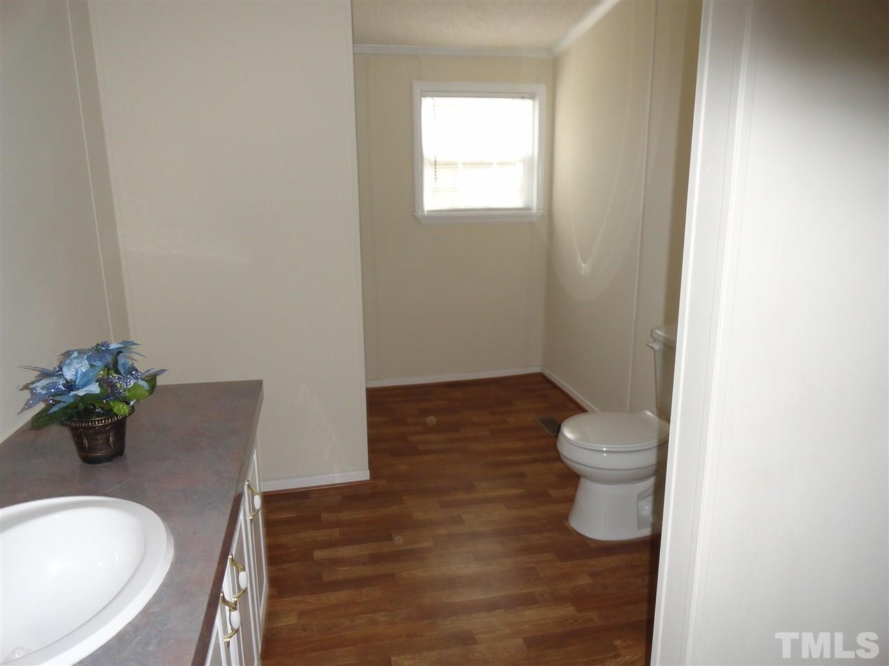3388 Dirgie Mine Road Roxboro, NC 27574 - Photo 12 of 12 a bathroom with a sink and a toilet