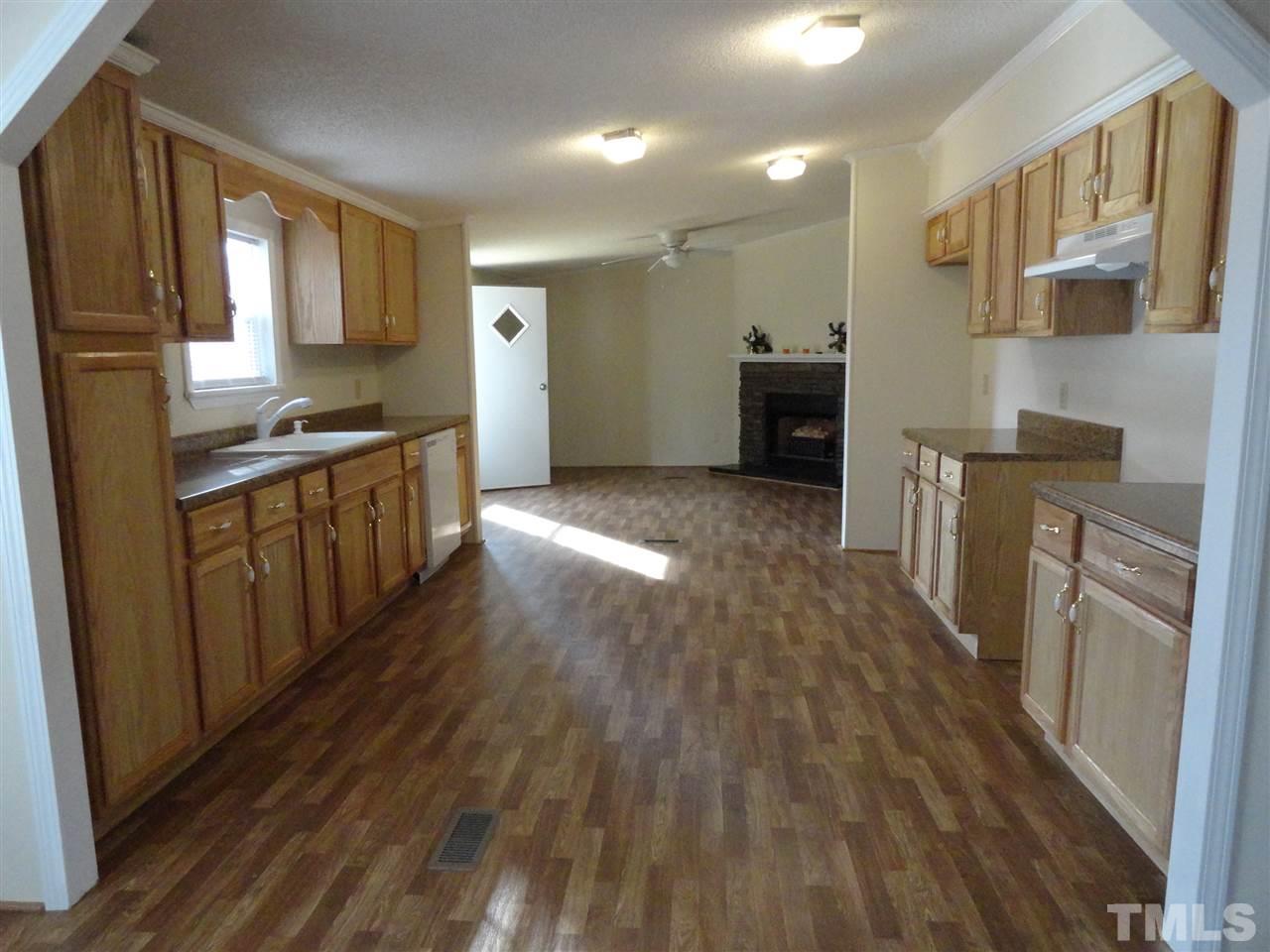 3388 Dirgie Mine Road Roxboro, NC 27574 - Photo 6 of 12 a kitchen with stainless steel appliances granite countertop a stove a sink and a refrigerator