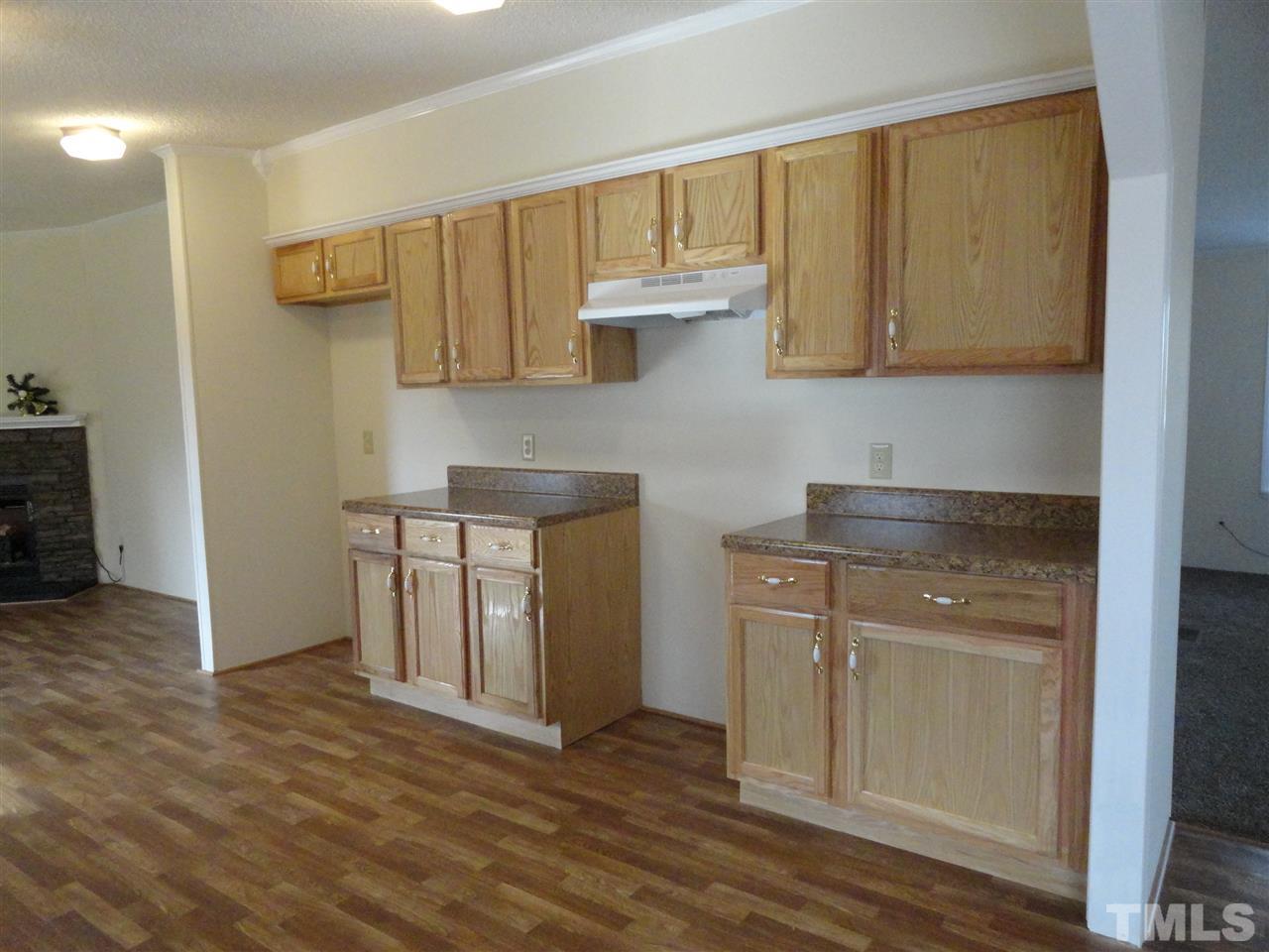 3388 Dirgie Mine Road Roxboro, NC 27574 - Photo 8 of 12 a kitchen with a sink cabinets and wooden floor