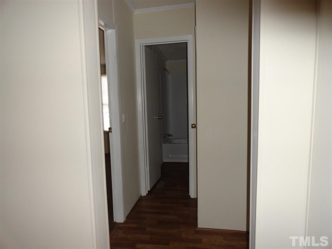 3388 Dirgie Mine Road Roxboro, NC 27574 - Photo 10 of 12 a view of a hallway with wooden floor
